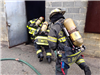 Firefighters Crouching Entering a Building During Training
