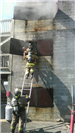 Training Exercise on a Ladder while a Firefighter Holds a Dummy