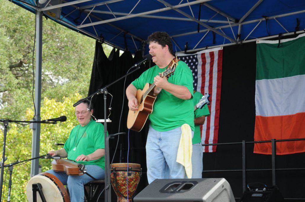 Two People Performing on Stage in Green