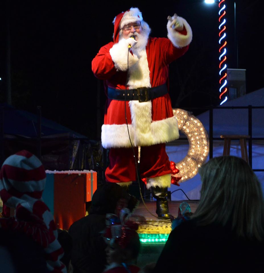 Santa Claus Talking into a Microphone to an Audience