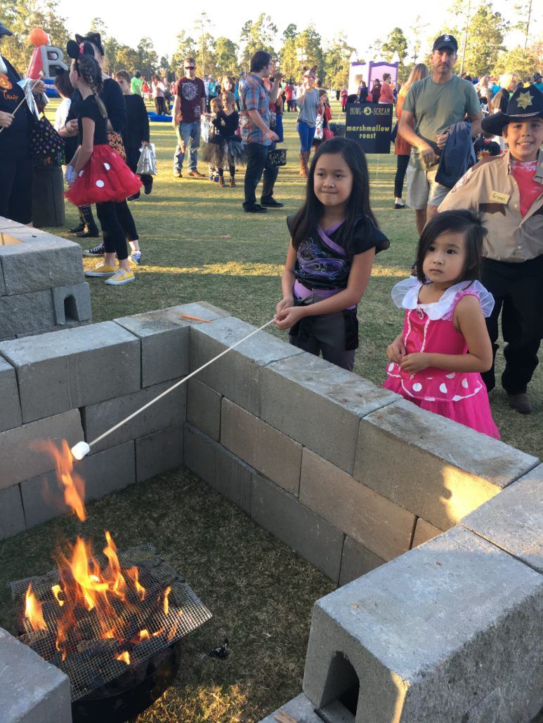 Children roasting marshmallows at a fire pit